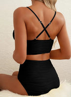 Woman wearing a black high-waisted elegant bikini set - lifestyle photo