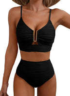 Woman wearing a black high-waisted elegant bikini set - studio photo