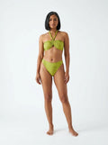 Woman wearing an olive green halter bikini set with bamboo swirl print, studio photography, front view