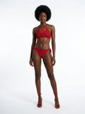 Woman wearing a red fringe bikini set, studio photography, front view