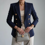 Woman wearing a blue double-breasted long sleeve blazer - editorial style photo