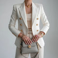Woman wearing a white double-breasted long sleeve blazer - editorial style photo