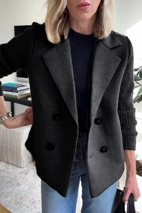 Woman wearing a black knit double-breasted blazer - studio photo