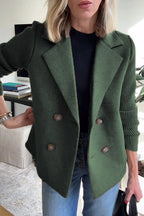 Woman wearing a green knit double-breasted blazer - studio photo