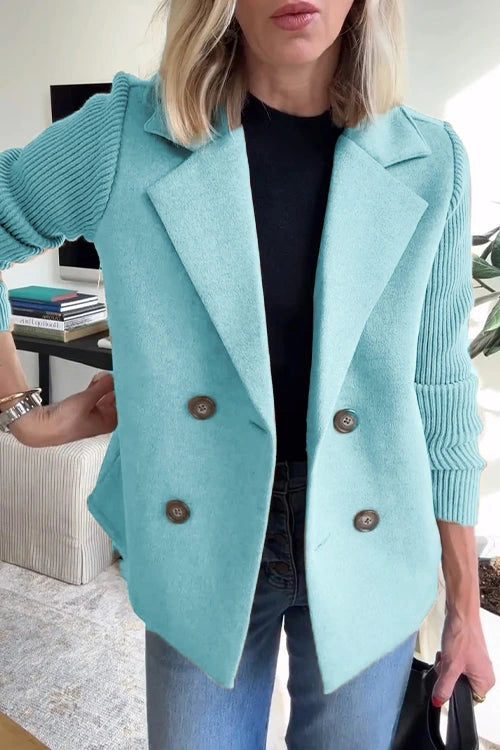 Woman wearing a light blue knit double-breasted blazer - studio photo