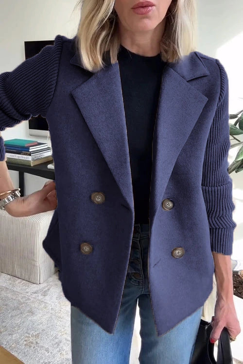 Woman wearing a navy knit double-breasted blazer - studio photo