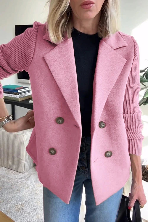 Woman wearing a pink knit double-breasted blazer - studio photo