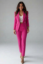 Woman wearing a magenta double-breasted button office blazer set - studio photo