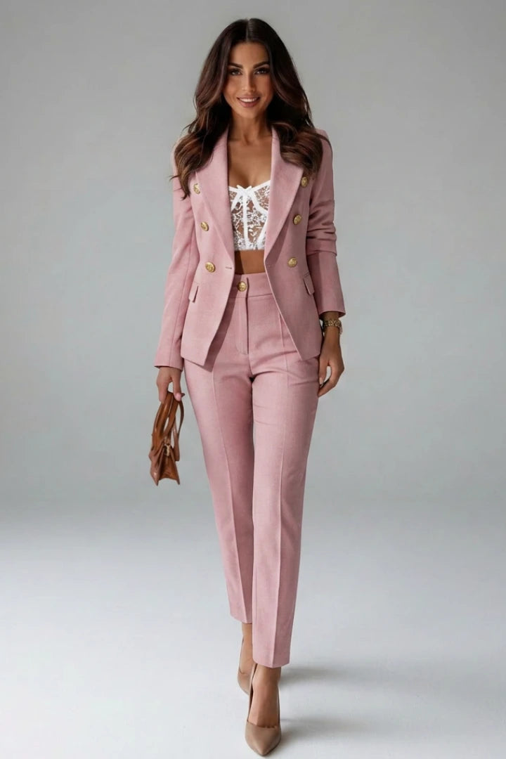 Woman wearing a pink double-breasted button office blazer set - studio photo