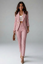 Woman wearing a pink double-breasted button office blazer set - studio photo