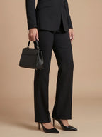 Woman wearing a black structured stand collar tailored blazer - studio photo