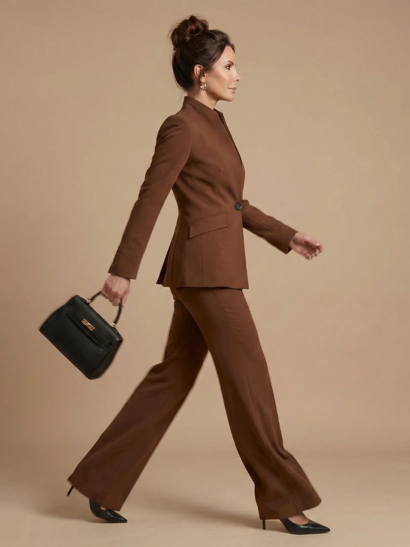 Woman wearing a brown structured stand collar tailored blazer - studio photo
