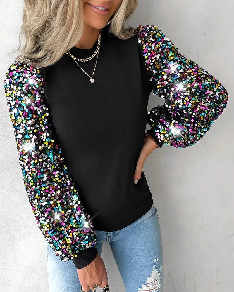 Driftly balloon sleeve sequin blouse in black, styled with jeans