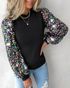 Driftly balloon sleeve sequin blouse in black, styled with jeans