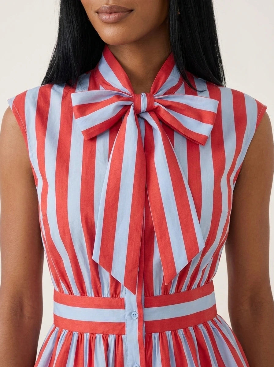 Close-up of striped blouse showing bowknot tie neck and peplum waist detail.