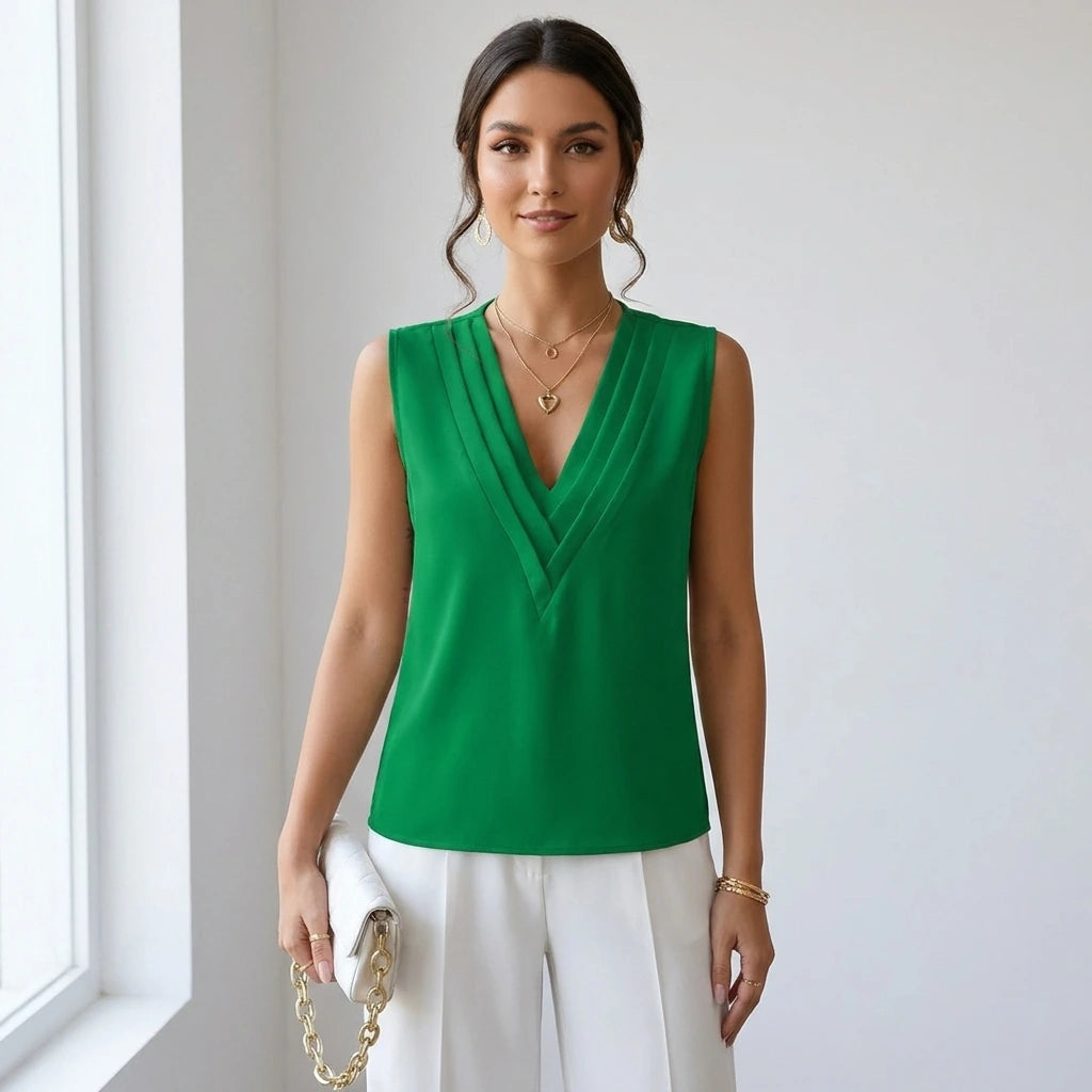 Driftly women's green sleeveless soft-touch blouse, styled with white wide-leg trousers in a minimalist studio setting.