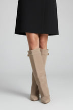 Woman wearing a beige suede wide opening block heel boot - studio photo