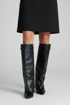 Woman wearing a black wide opening block heel boot - studio photo