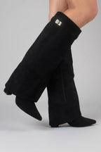 Woman wearing a black suede wide opening block heel boot - studio photo