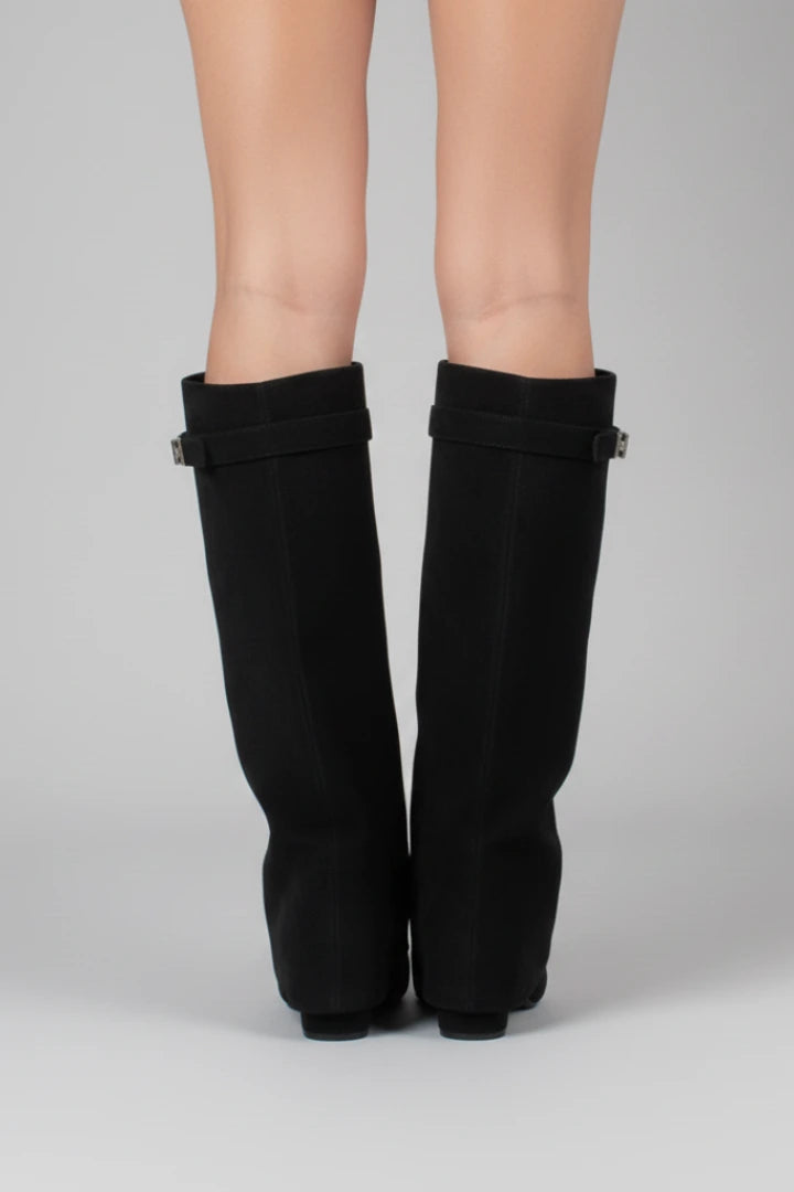 Woman wearing a black suede wide opening block heel boot - studio photo