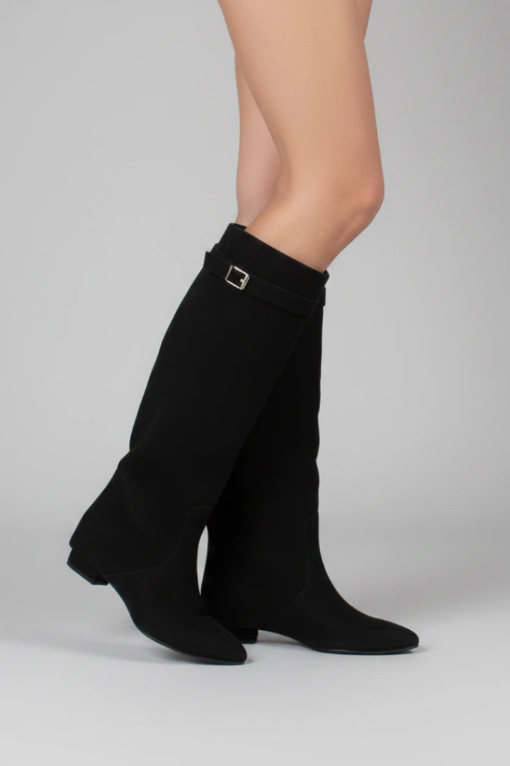 Woman wearing a black suede wide opening block heel boot - studio photo