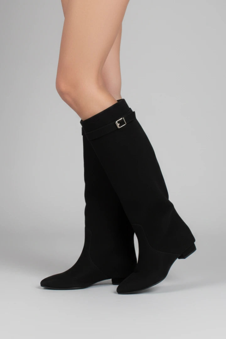 Woman wearing a black suede wide opening block heel boot - studio photo