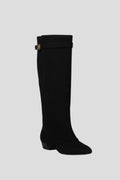 Woman wearing a black suede wide opening block heel boot - studio photo