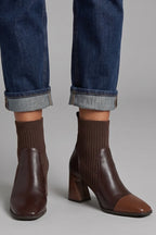 Woman wearing brown block heel ankle boots - lifestyle photo