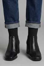 Woman wearing brown block heel ankle boots - lifestyle photo