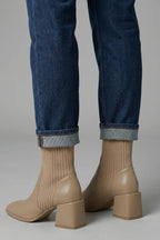 Woman wearing khaki block heel ankle boots - lifestyle photo
