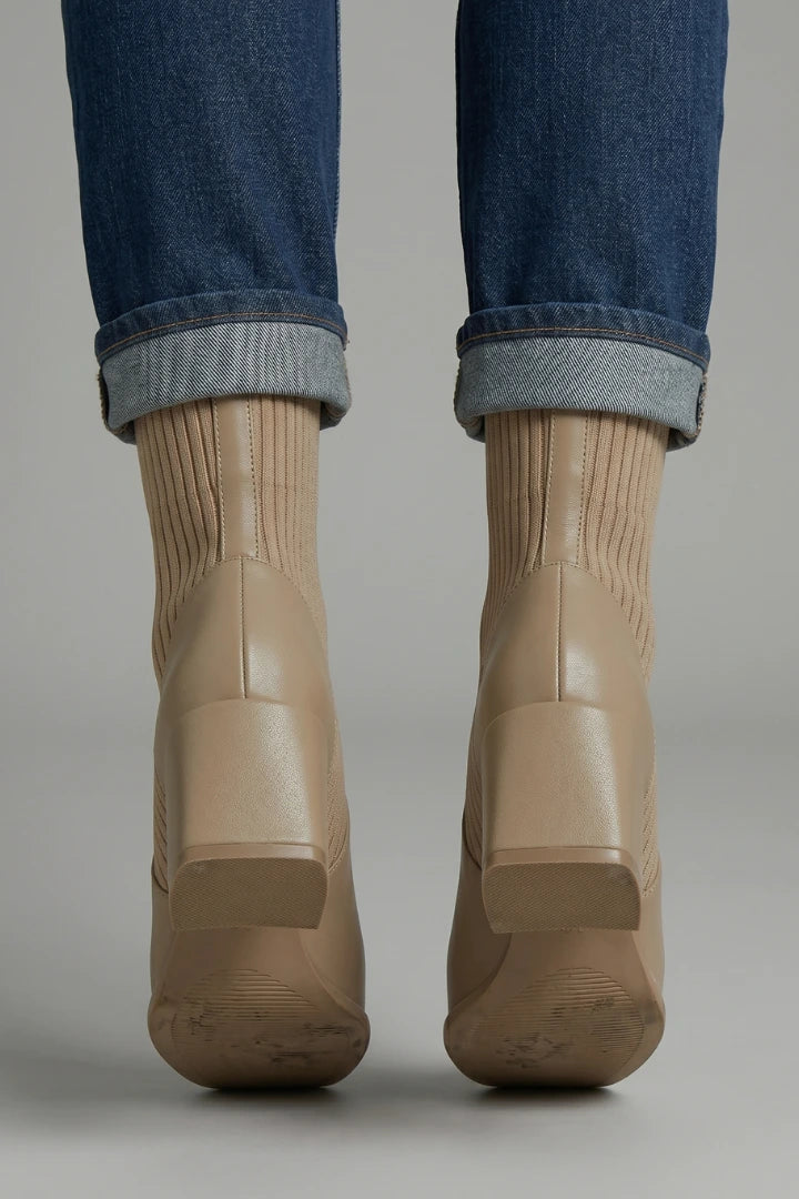 Woman wearing khaki block heel ankle boots - lifestyle photo