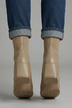 Woman wearing khaki block heel ankle boots - lifestyle photo