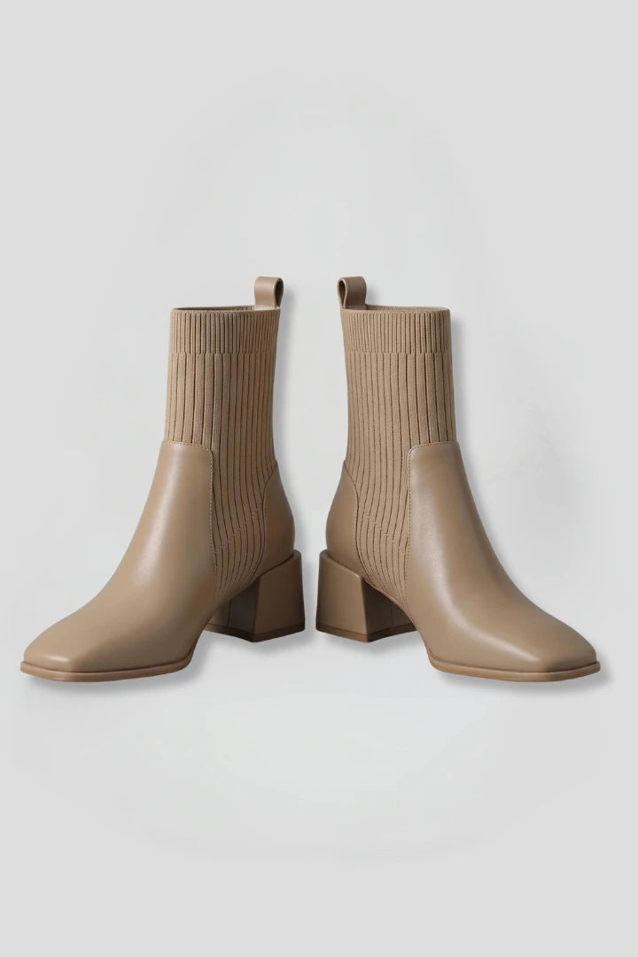 Woman wearing khaki block heel ankle boots - studio photo