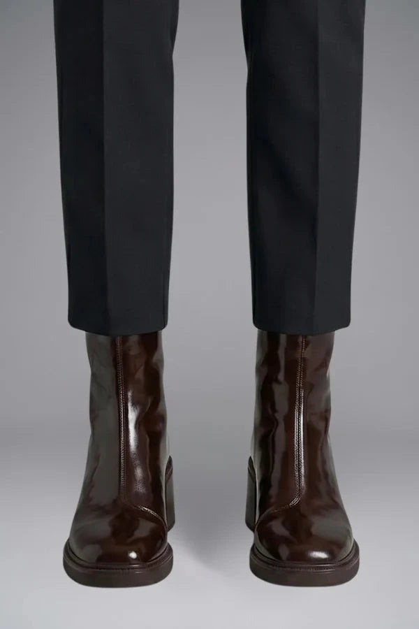 Woman wearing brown block heel side zipper ankle boots - lifestyle photo