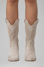 Woman wearing beige low block heel fall boots - lifestyle photo