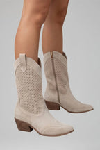 Woman wearing beige low block heel fall boots - lifestyle photo