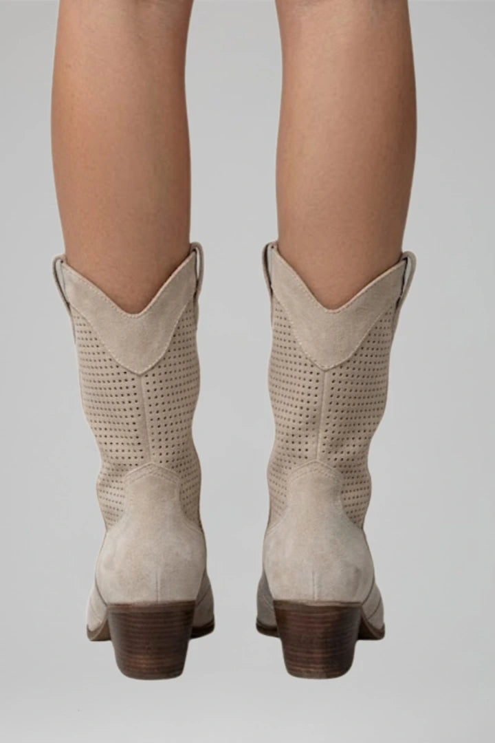 Woman wearing beige low block heel fall boots - lifestyle photo