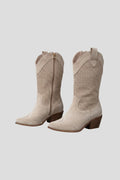 Woman wearing beige low block heel fall boots - studio photo