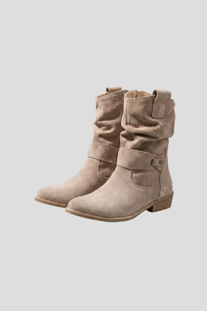 Woman wearing beige mid-calf side zipper boots - studio photo