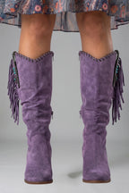 Woman wearing purple orthopedic block heel boots - studio photo
