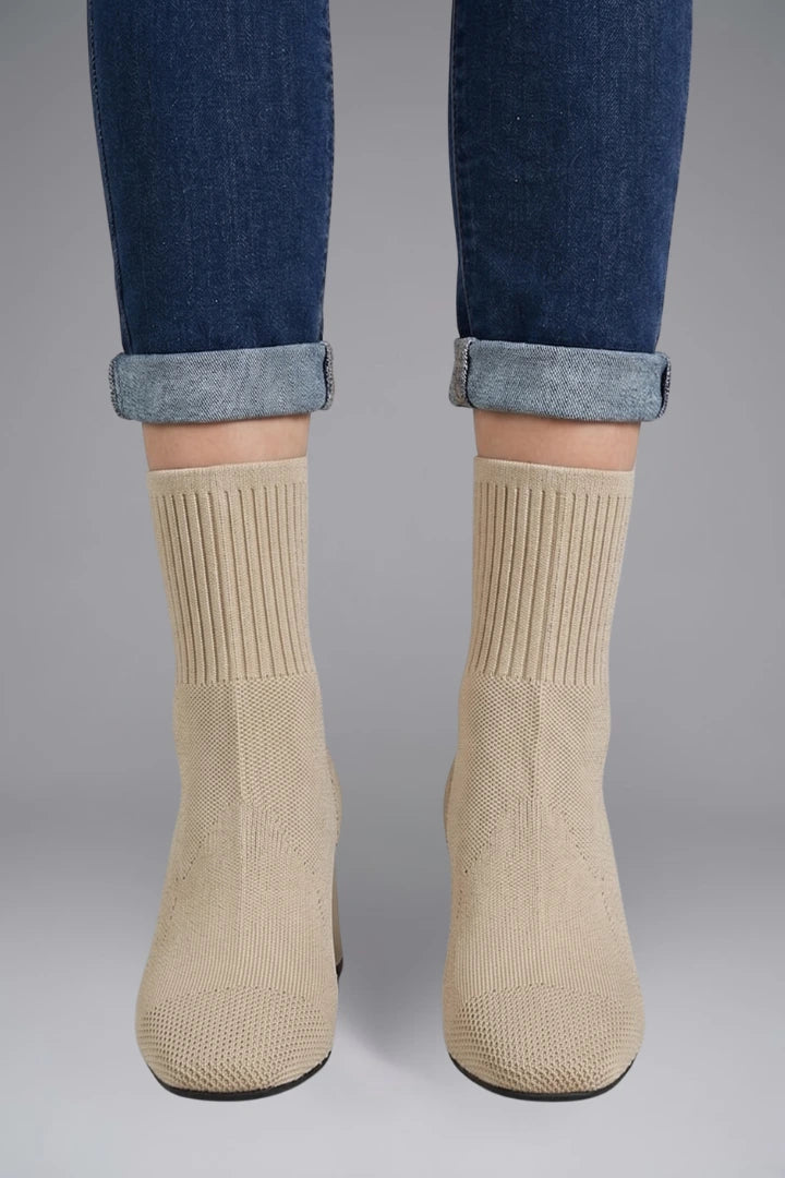 Woman wearing beige ribbed stretch ankle boots - lifestyle photo