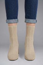 Woman wearing beige ribbed stretch ankle boots - lifestyle photo