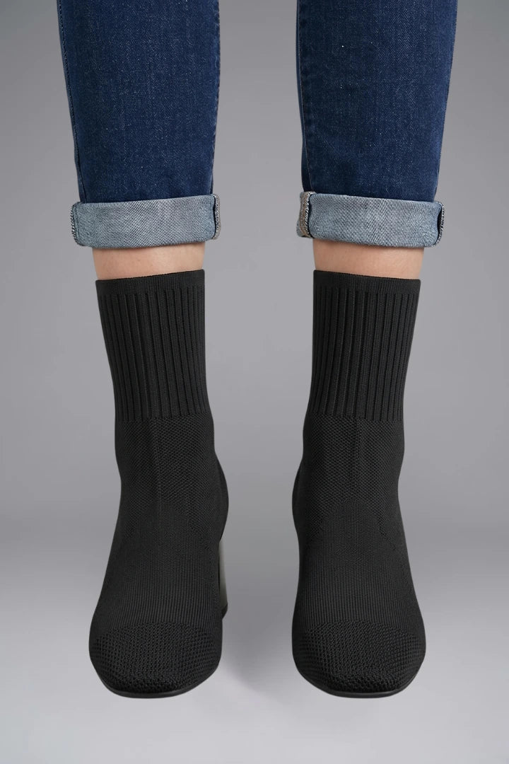Woman wearing black ribbed stretch ankle boots - lifestyle photo