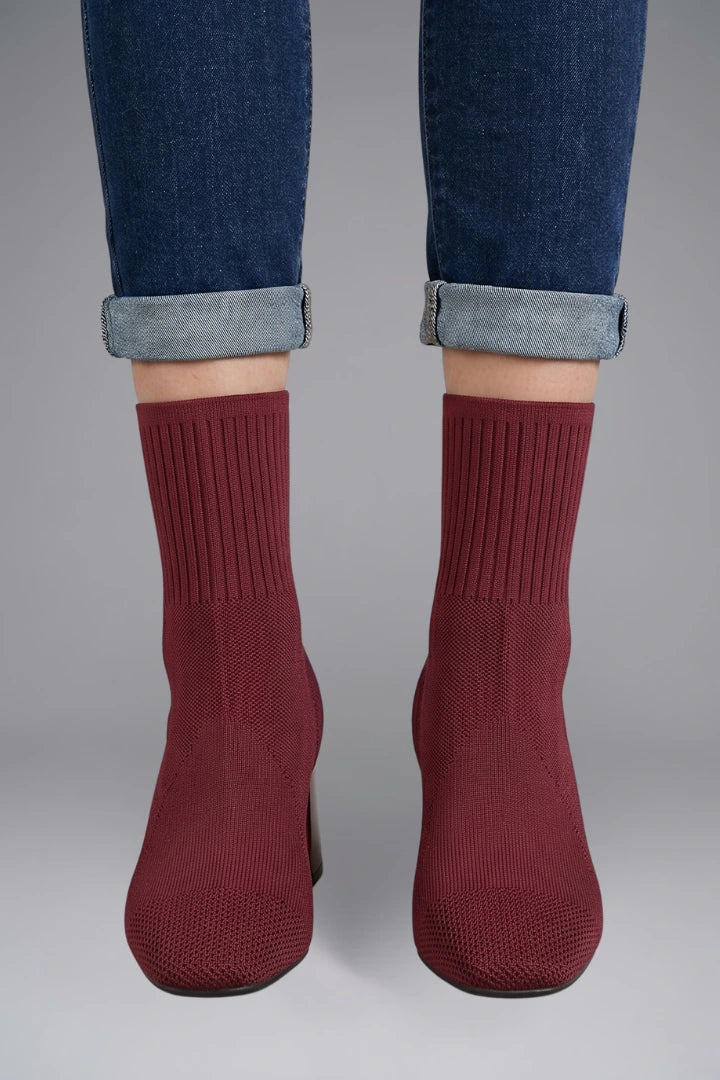 Woman wearing burgundy ribbed stretch ankle boots - lifestyle photo