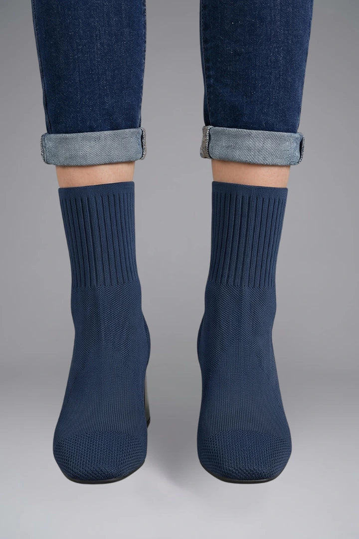 Woman wearing navy blue ribbed stretch ankle boots - lifestyle photo