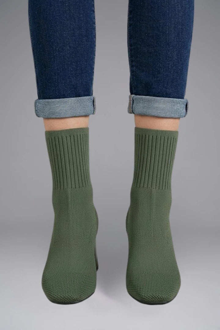 Woman wearing olive green ribbed stretch ankle boots - lifestyle photo