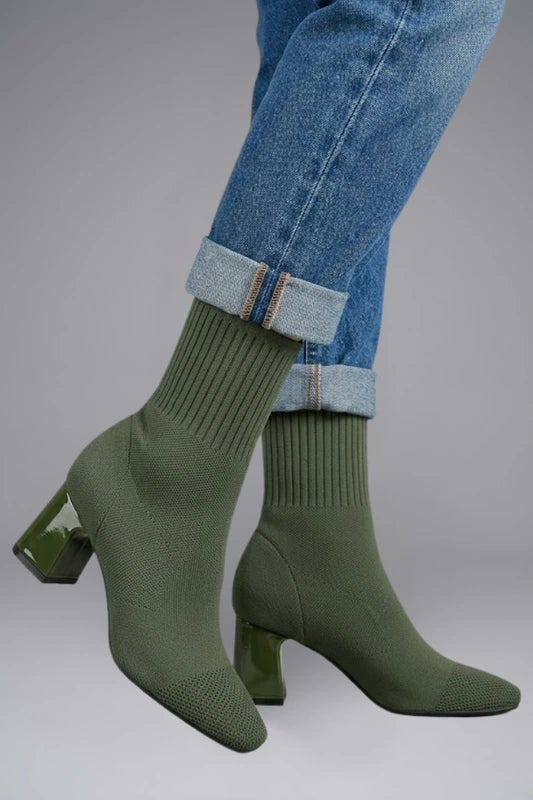 Woman wearing olive green ribbed stretch ankle boots - lifestyle photo