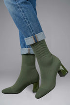 Woman wearing olive green ribbed stretch ankle boots - lifestyle photo
