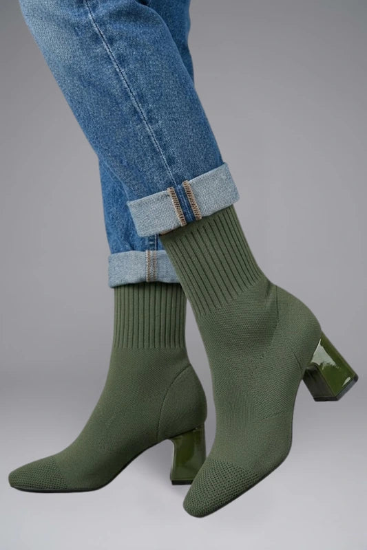 Woman wearing olive green ribbed stretch ankle boots - lifestyle photo