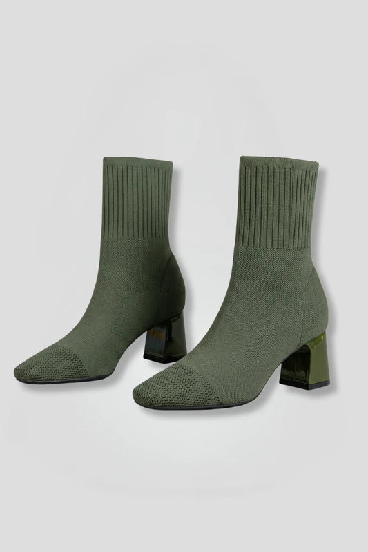 Woman wearing olive green ribbed stretch ankle boots - studio photo